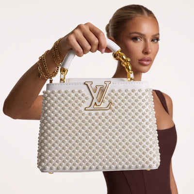 White Louis Vuitton top-handle bag with pearl studs and gold LV logo