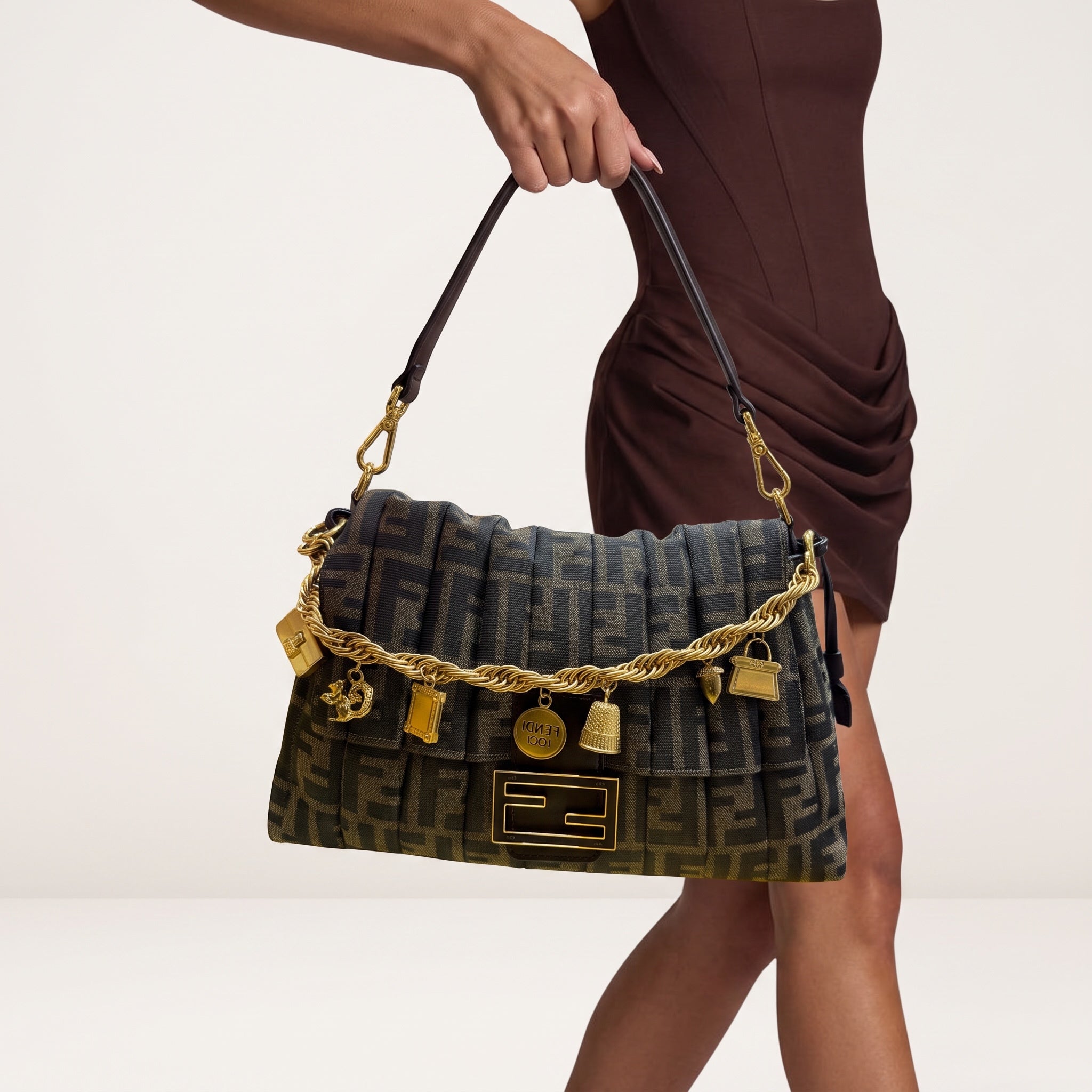 Fendi baguette bag in brown Zucca monogram with gold charm chain