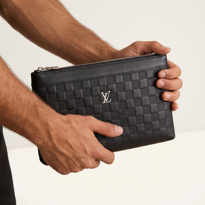 Black Louis Vuitton Damier clutch with silver LV logo and top zip