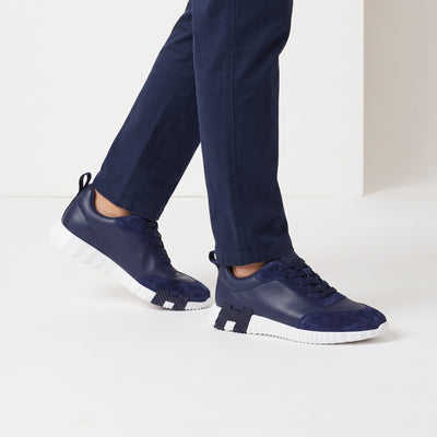 navy low-top sneakers with suede overlays and white ridged sole
