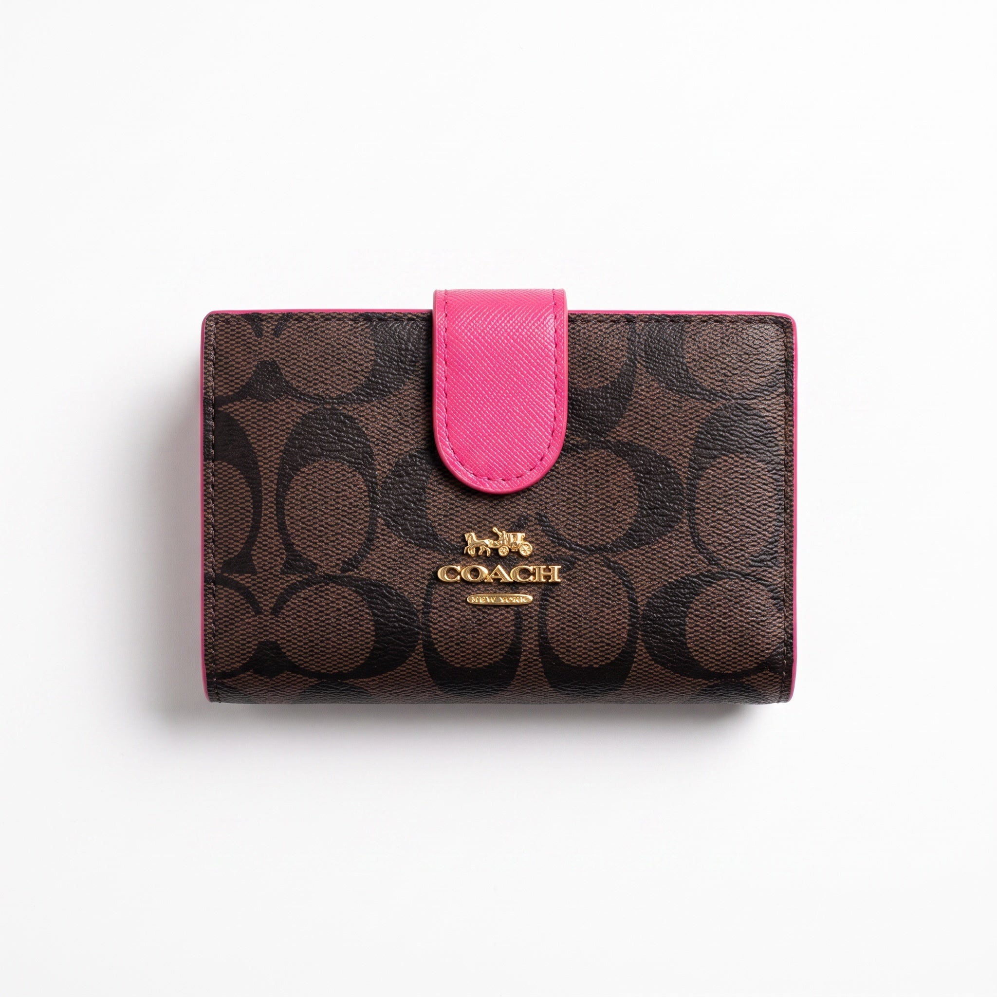 Coach brown signature logo wallet with hot pink trim and gold logo plaque