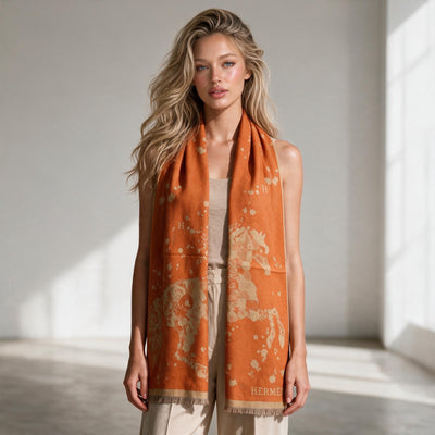 Orange Hermès scarf with floral motif, "H" logo and fringed edges