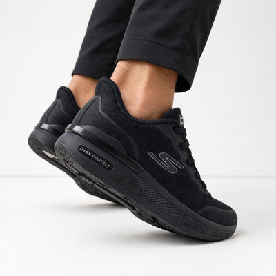 All‑black Skechers low‑top sneakers with Max Protect sole