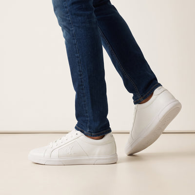 White Calvin Klein low-top sneakers with embossed CK logo