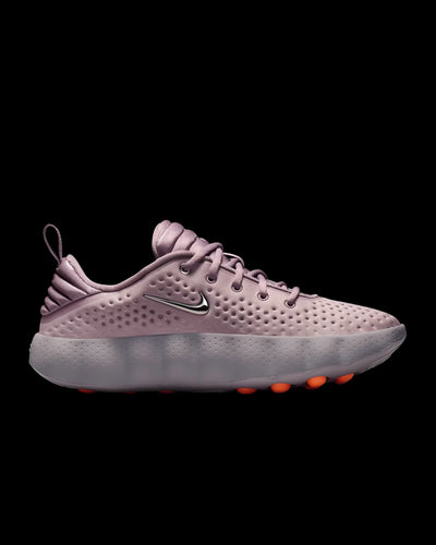 dusty pink nike sneaker with perforated upper and orange pod outsole