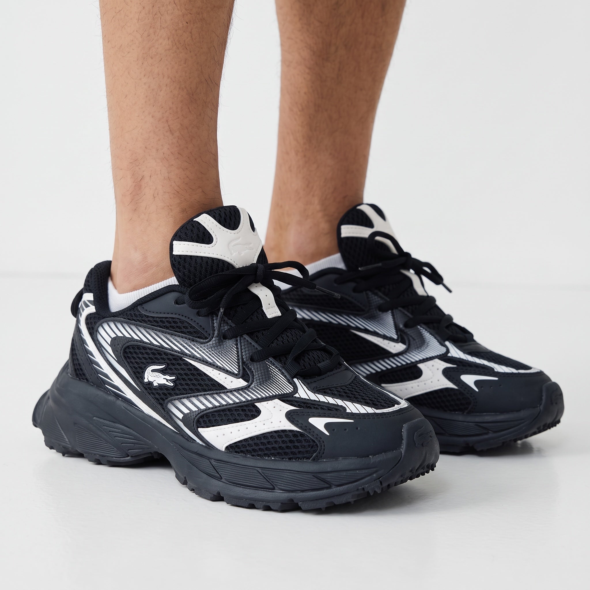 Lacoste black and white chunky low-top sneakers with mesh panels and crocodile logo