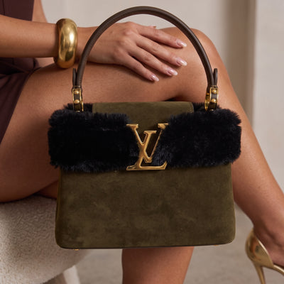 Olive suede Louis Vuitton top-handle bag with black fur trim and gold LV plaque