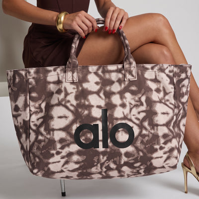 brown tie-dye printed Alo tote bag with top zip and handles