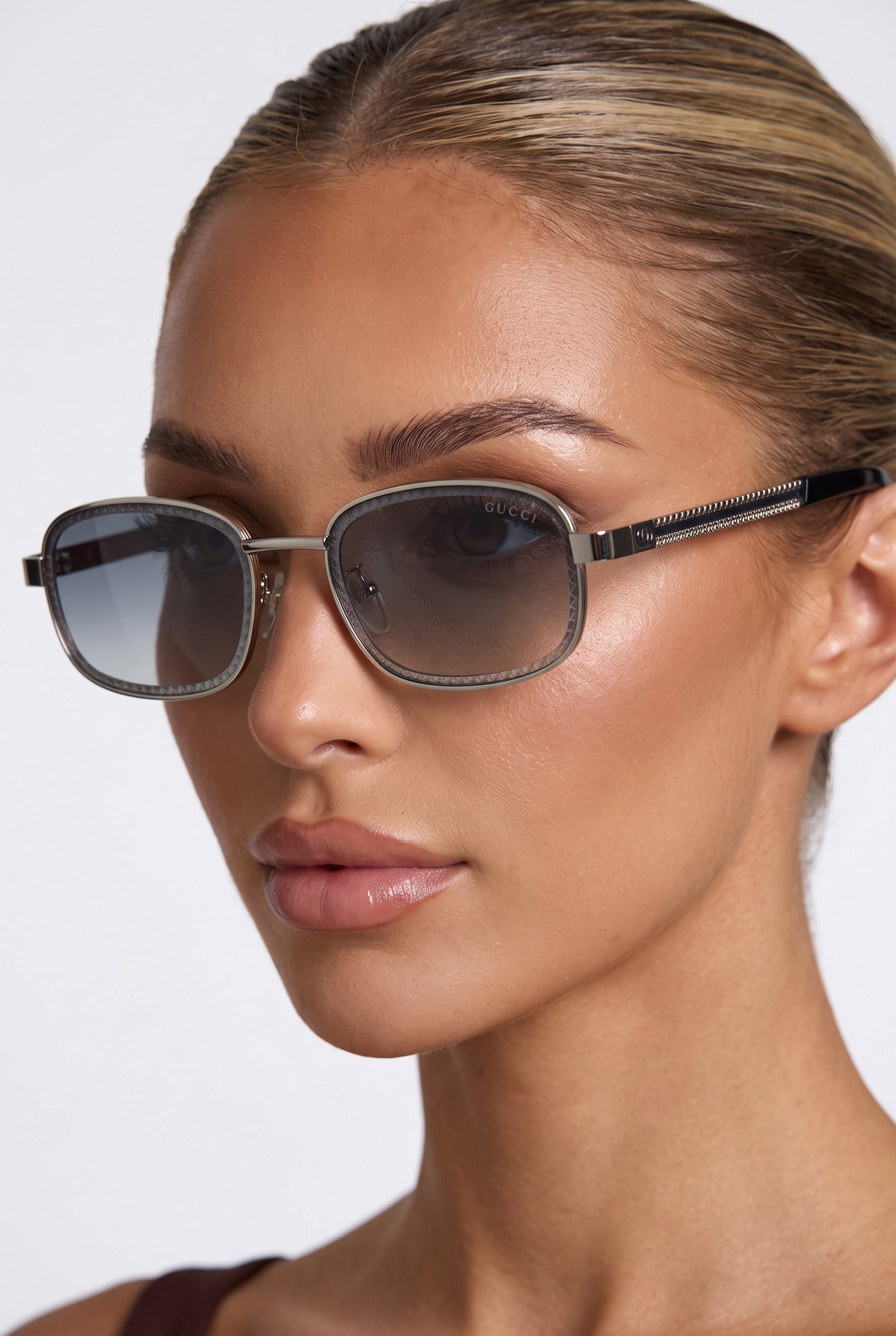 Close-up of Gucci square silver sunglasses with grey gradient lenses