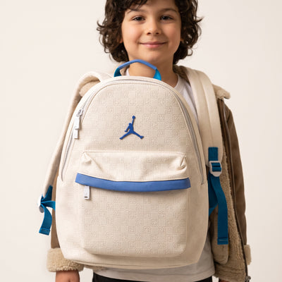Cream Jordan backpack with embossed 23 pattern and blue trim