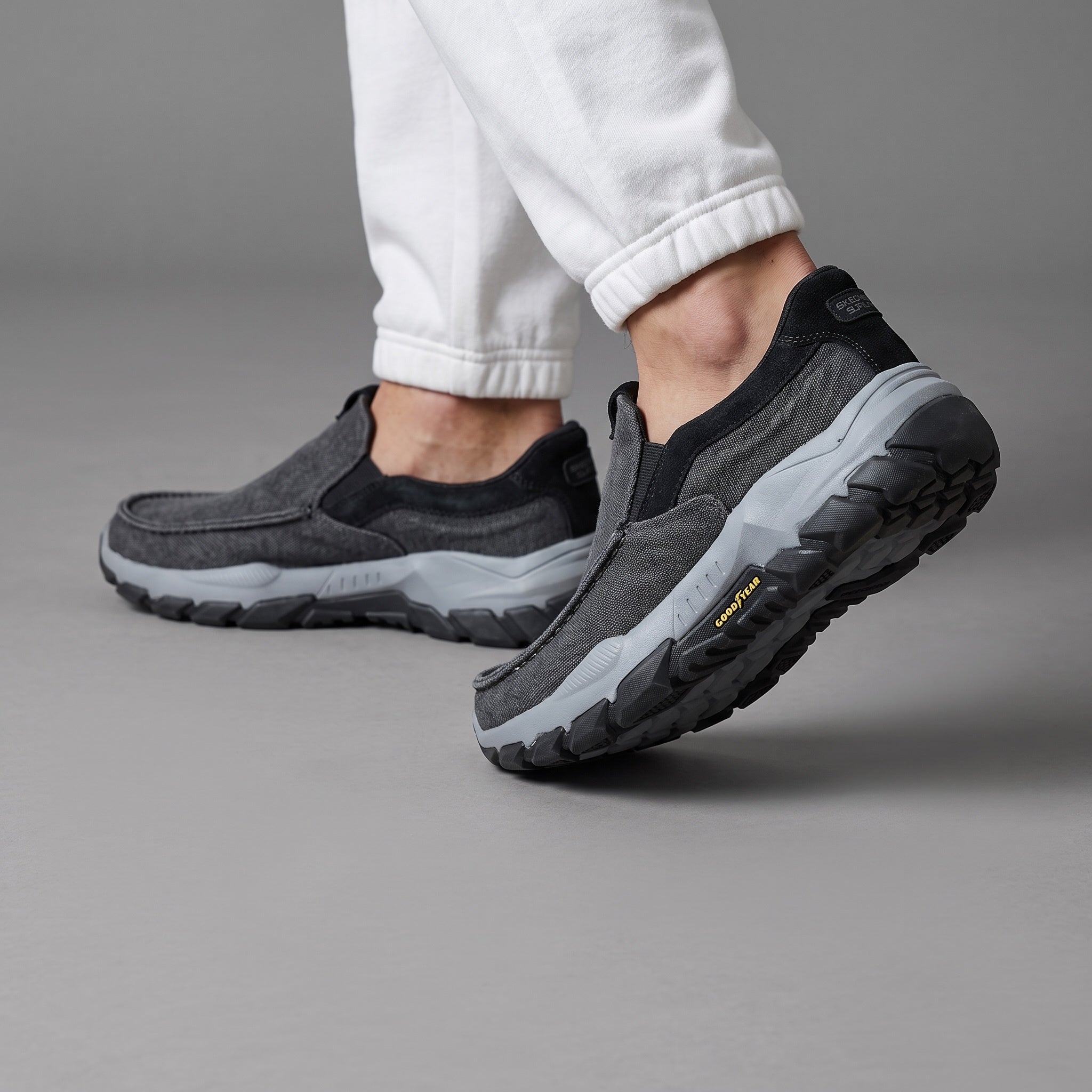 charcoal grey Skechers slip-on trainer with chunky grey lug sole and Goodyear logo