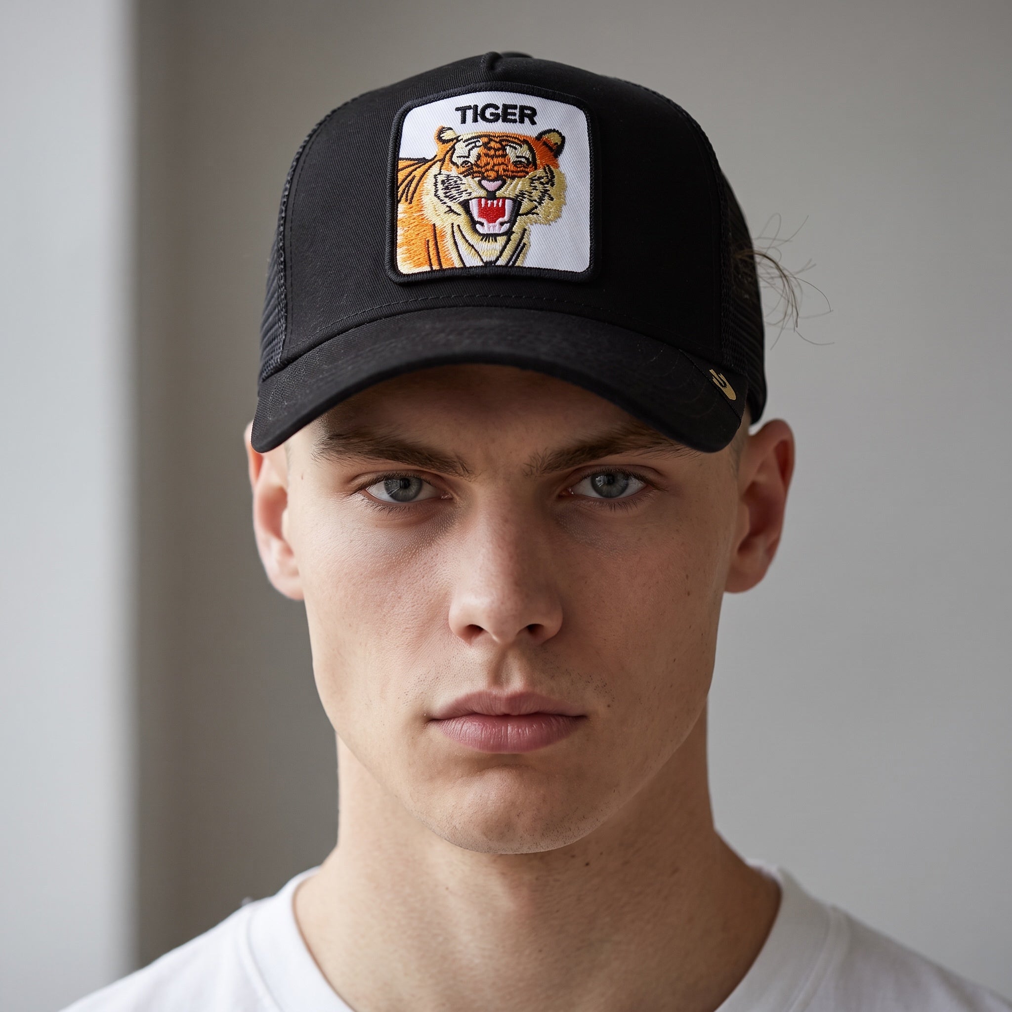 Black trucker cap with embroidered tiger patch on front