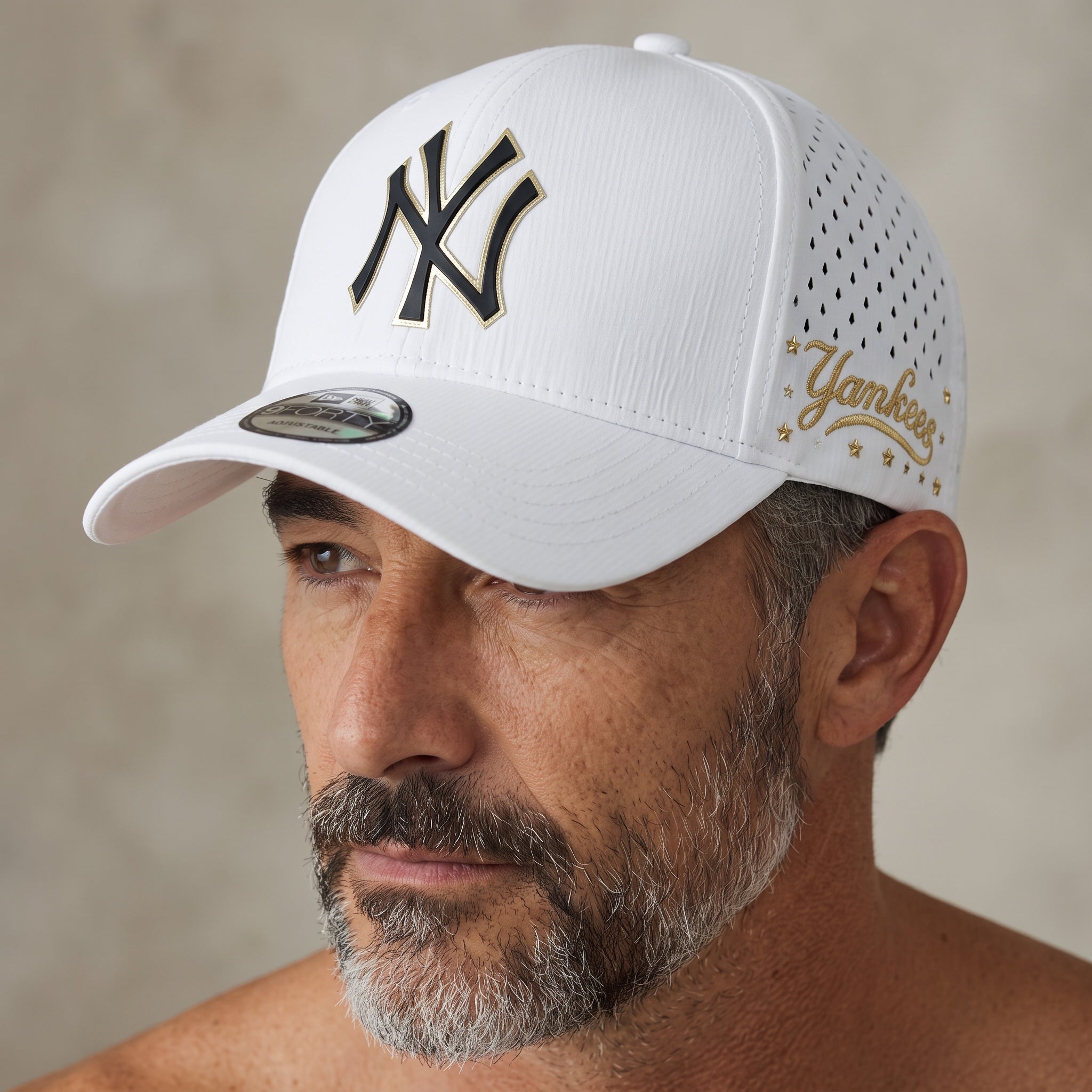 White New Era Yankees 9FORTY baseball cap with gold accents, worn by a man