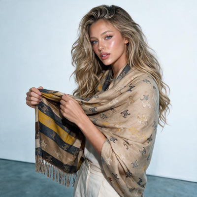 camel coloured scarf with repeating Triomphe monogram motif and fringed ends wrapped around model