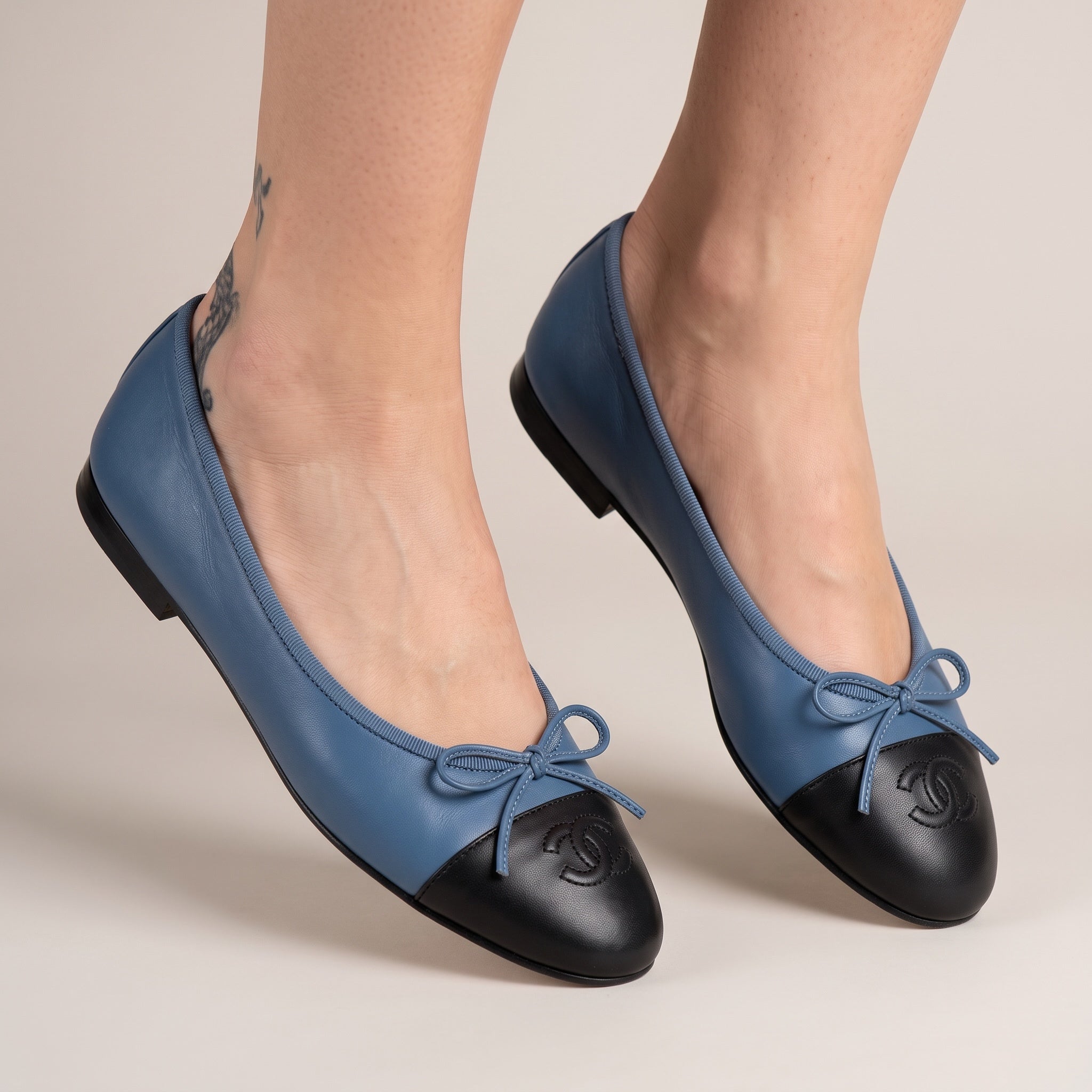 Chanel two-tone blue and black ballet flats with stitched CC logo on cap toe