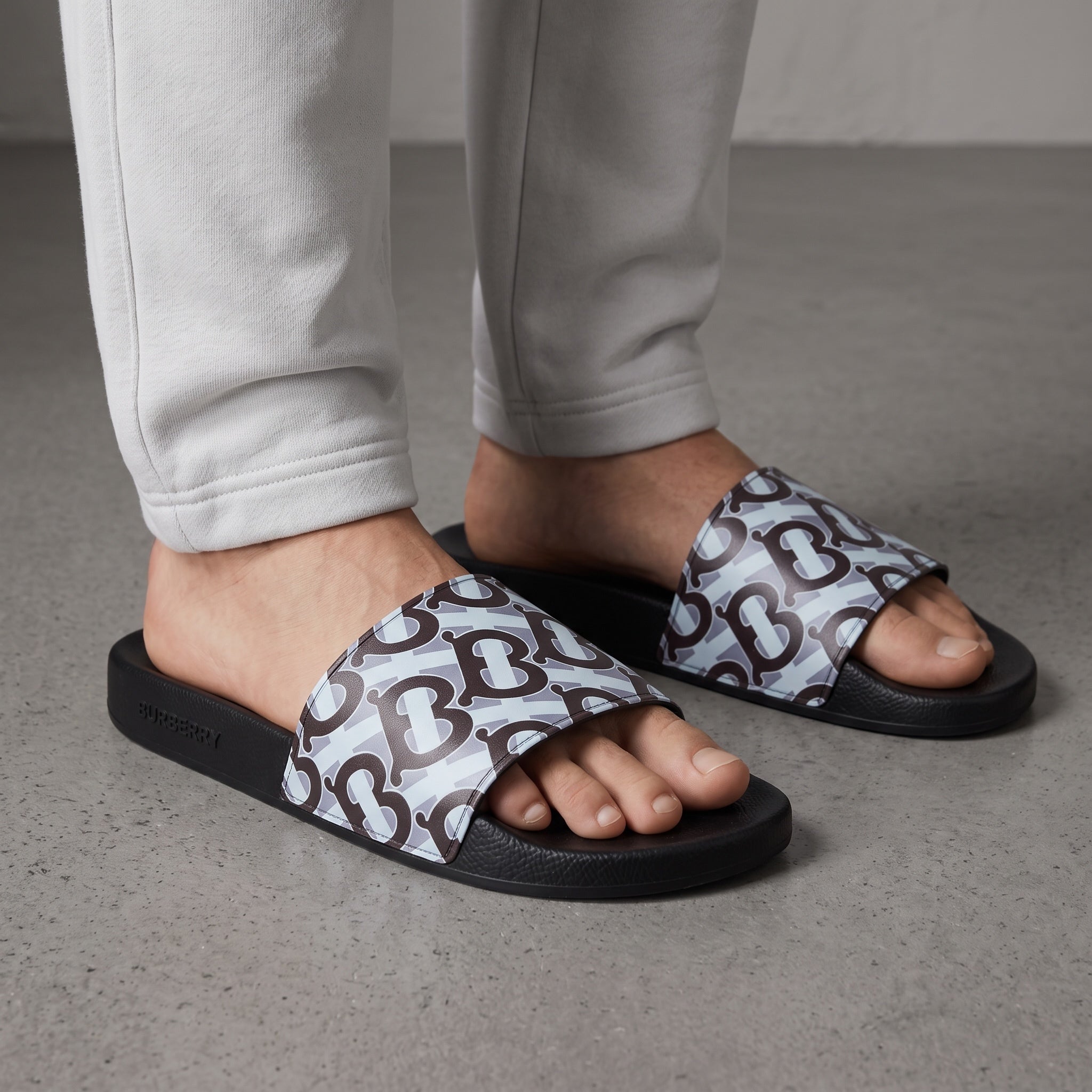 Burberry TB monogram slide sandals with black sole and light blue patterned strap