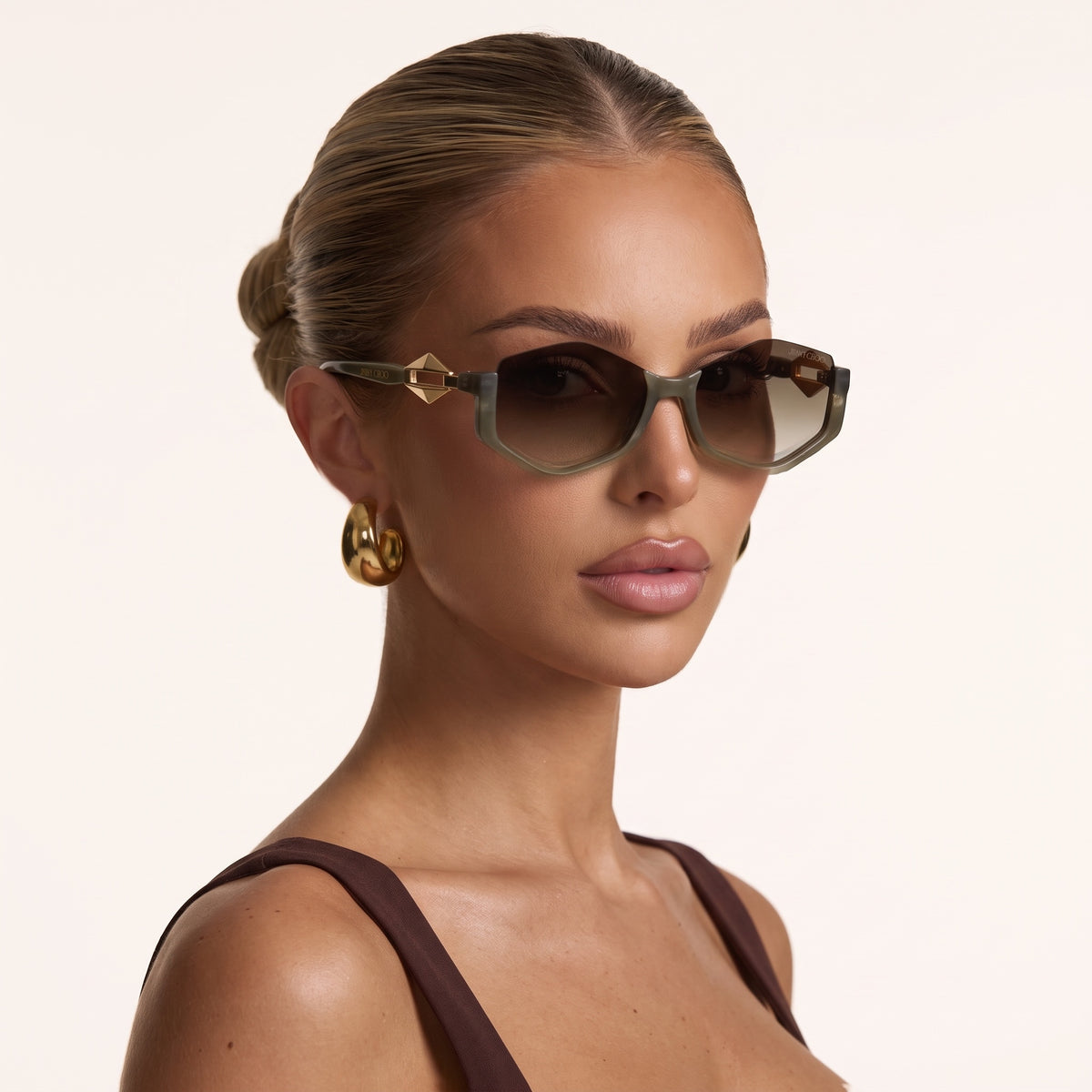 Jimmy Choo olive green translucent sunglasses with gold pyramid temple hardware and brown gradient lenses