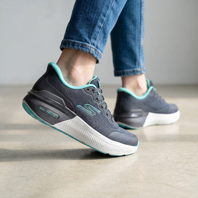Grey Skechers sneakers with teal trim and visible Max Protect heel