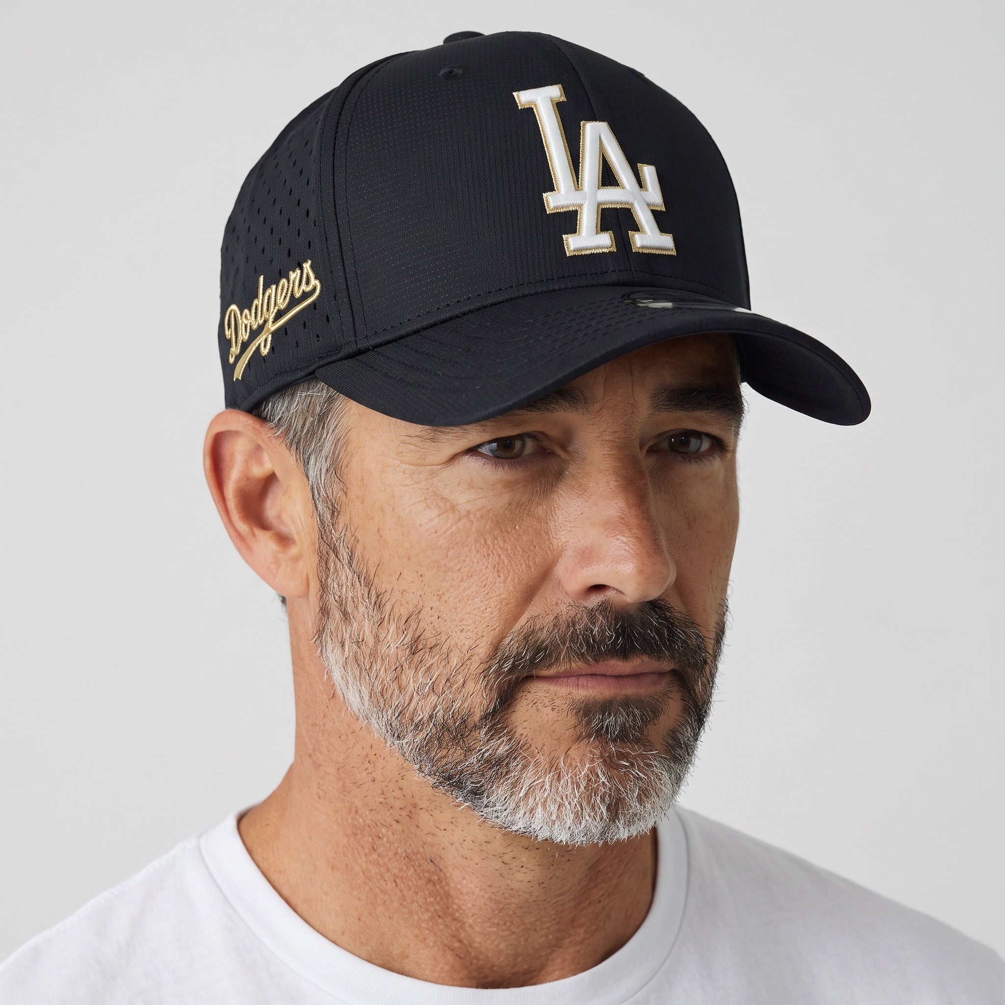 Man wearing a black LA Dodgers baseball cap with white and gold embroidered logo