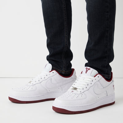 White low-top Nike Air Force 1 with burgundy accents, textured upper, Kobe logo and number 33 on heel