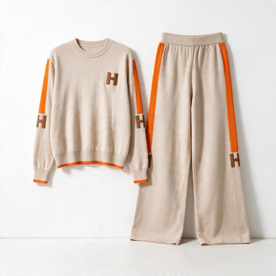 Beige knit two-piece tracksuit with orange side stripes and H logo patches