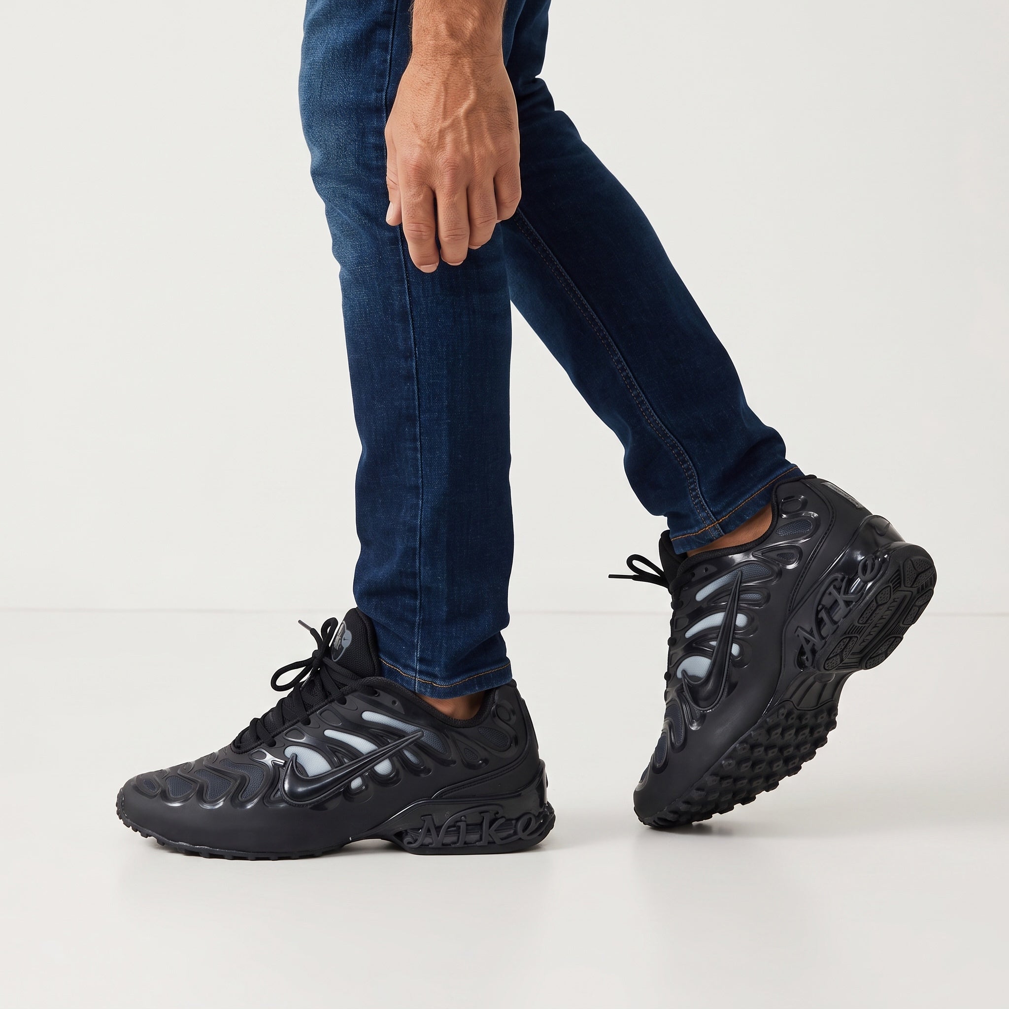 pair of black Nike wavy-cage chunky sneakers shown on model