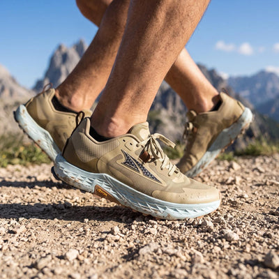 Altra tan trail running shoe with light blue midsole and Vibram sole