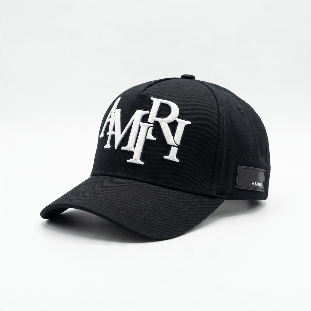 Black Amiri baseball cap with white embroidered logo and side patch.