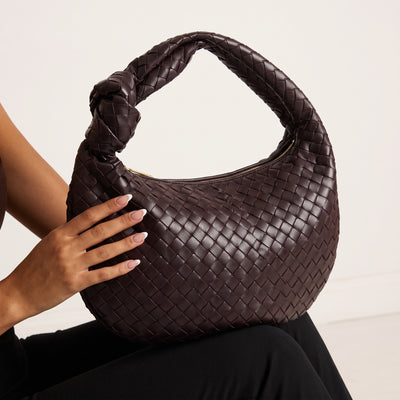 Dark brown woven hobo bag with braided handle and gold zipper