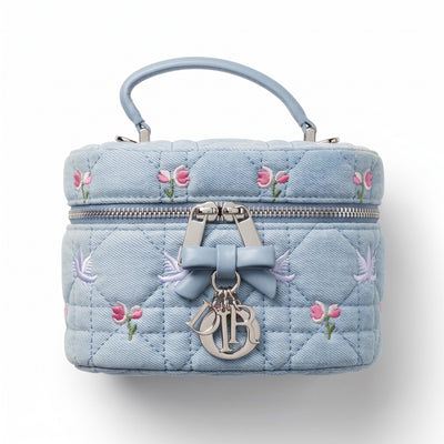 baby blue Dior quilted vanity pouch with embroidered flowers and silver Dior charms