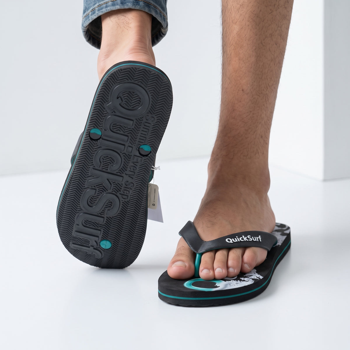 QuickSurf black and teal flip flops with graphic footbed and textured strap
