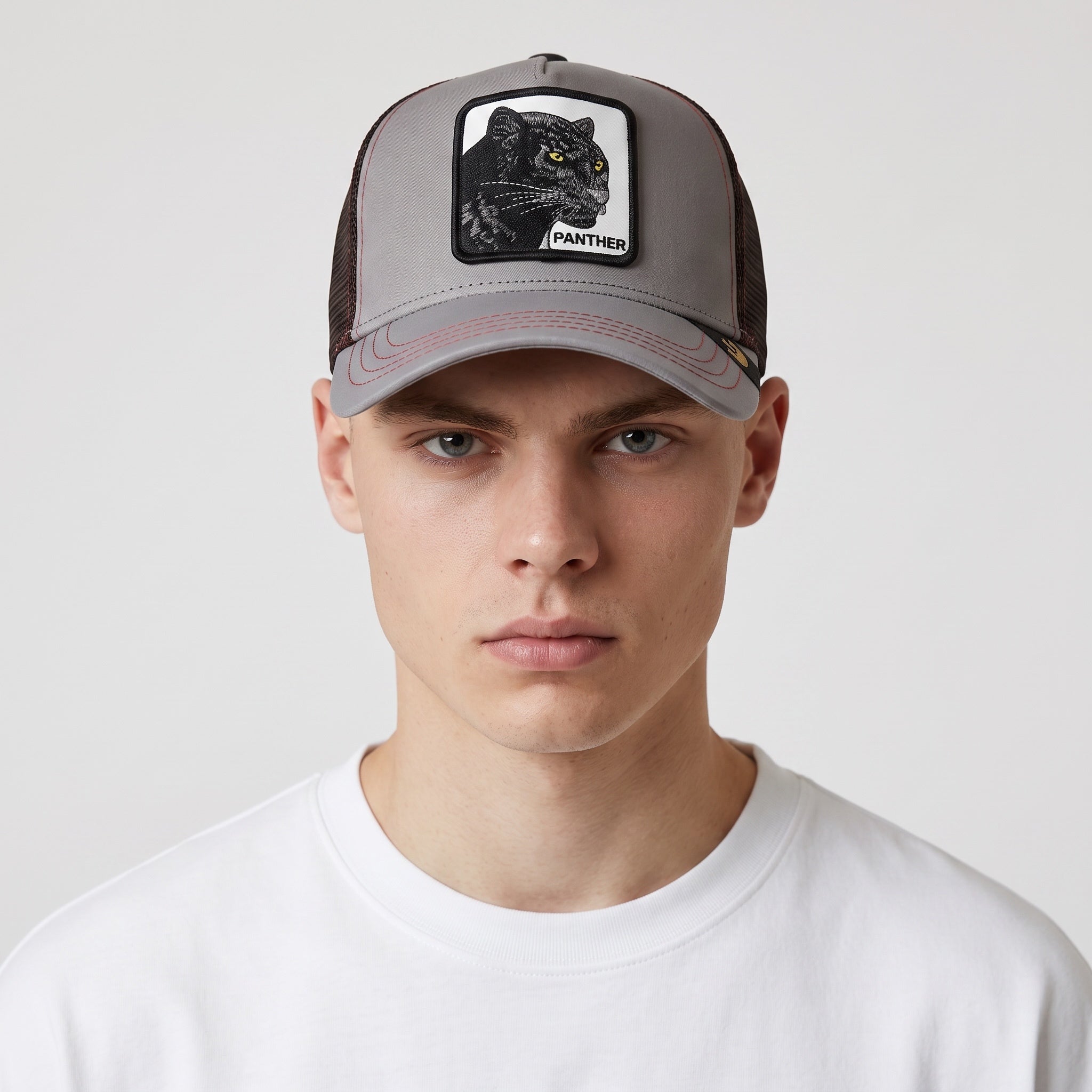 Grey trucker cap with black panther embroidered patch and brown mesh back