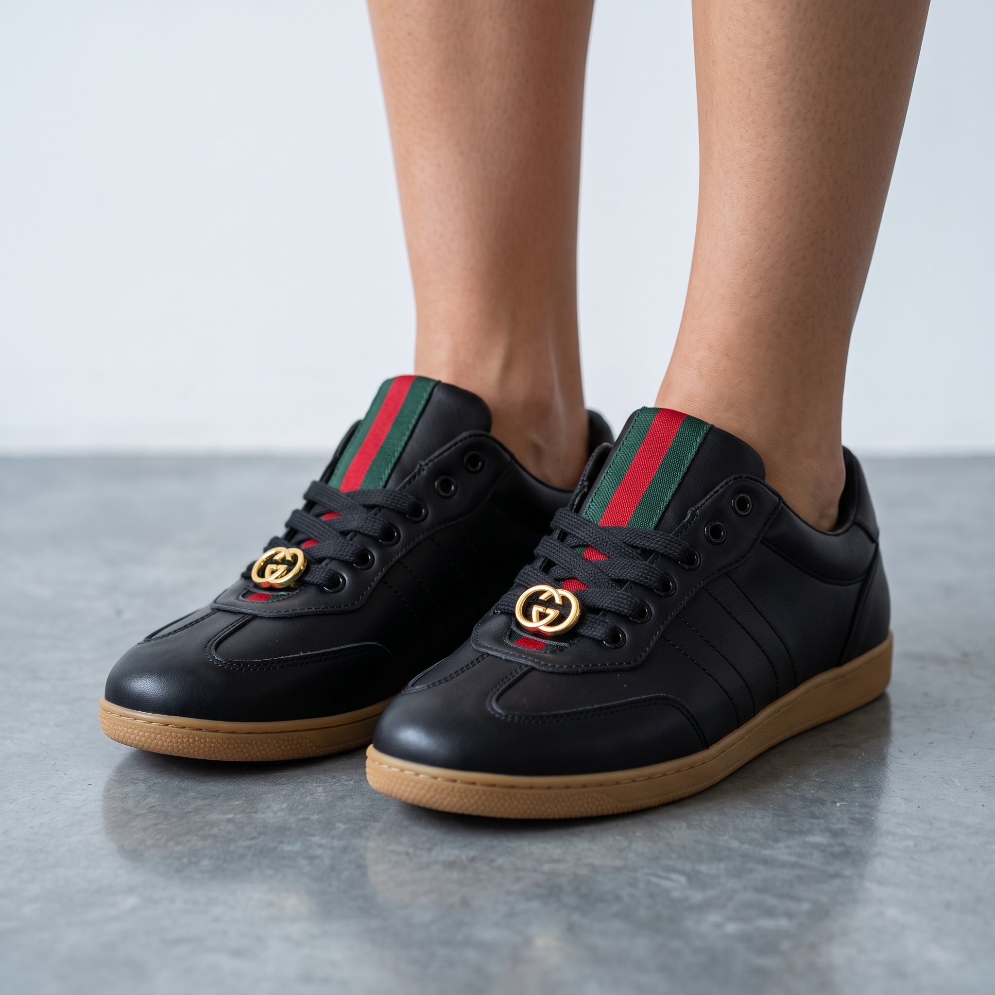 black Gucci Ace sneakers with green red web and gold GG on gum sole