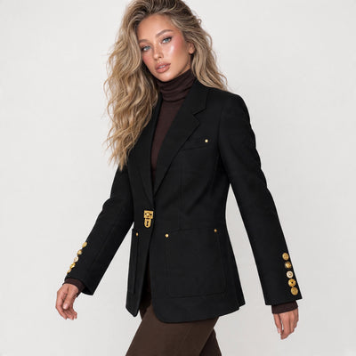 Black tailored blazer with gold clasp and gold sleeve buttons