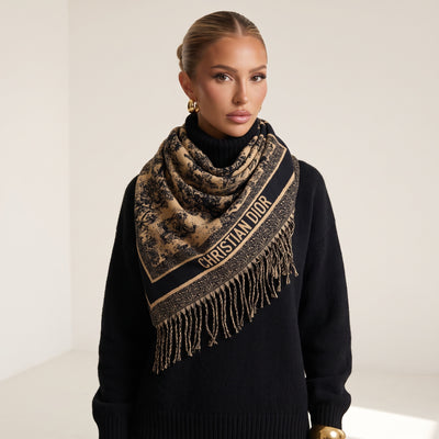 Beige and black Christian Dior logo scarf with fringed ends draped over a model