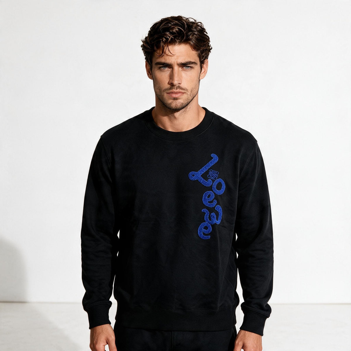 Black Loewe crewneck sweatshirt with blue vertical logo on right side