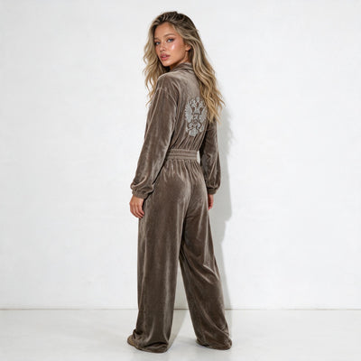 taupe velour jumpsuit with half zip collar, elastic waist, wide legs and embellished crest on chest and back