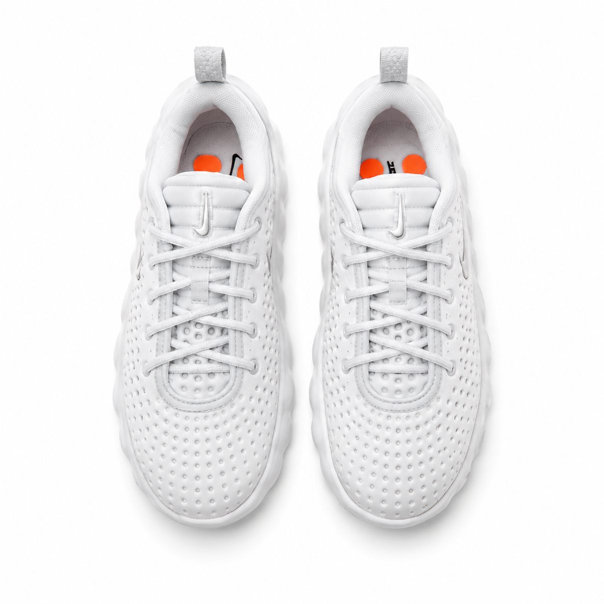 White Nike perforated sneakers with orange pod sole shown from multiple angles