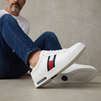 white Tommy Hilfiger low-top sneaker with navy and red stripe and branded midsole