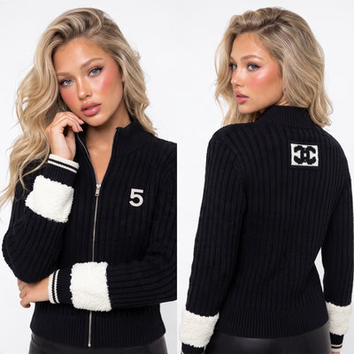 Black ribbed Chanel zip cardigan with white contrast cuffs, embellished 5 patch and logo square on back