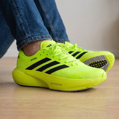 Adidas Adizero Supernova neon yellow running sneakers with black stripes