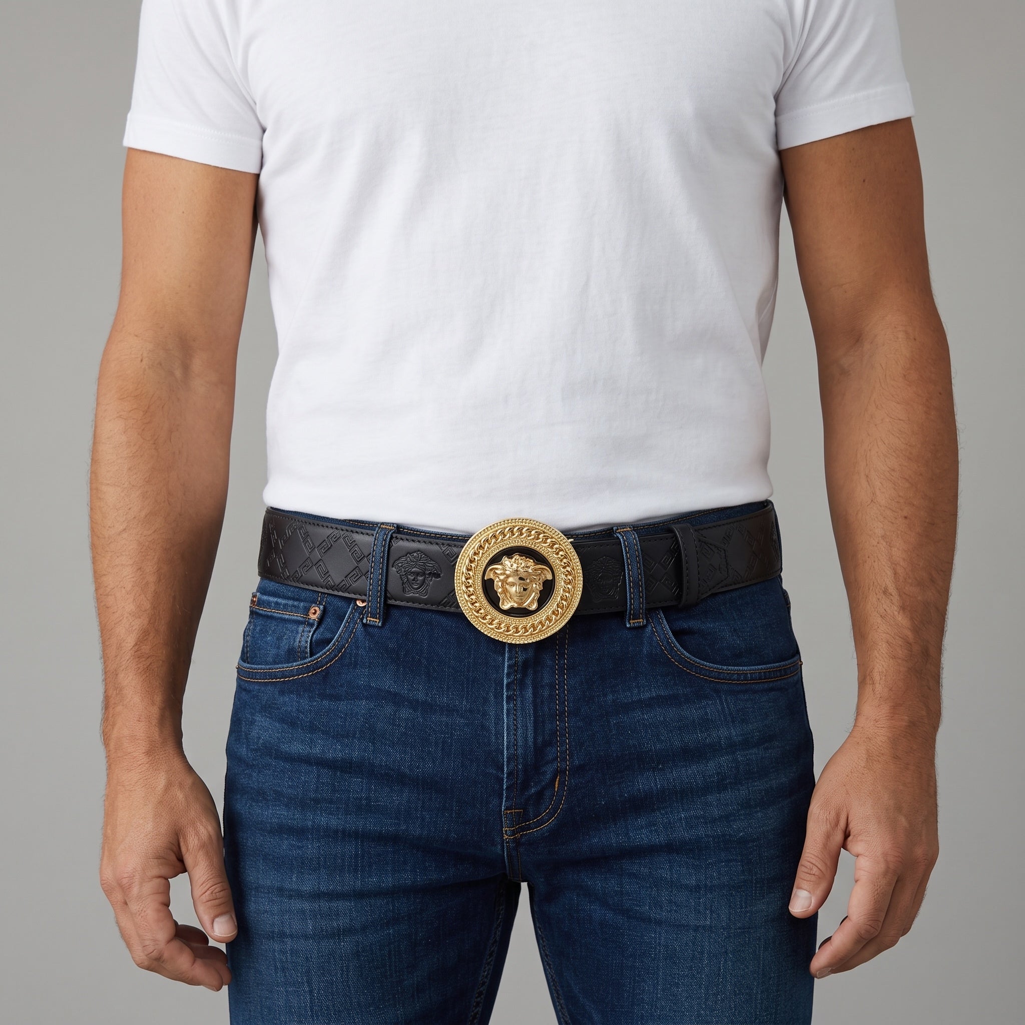 Black Versace belt with gold Medusa round buckle worn with jeans