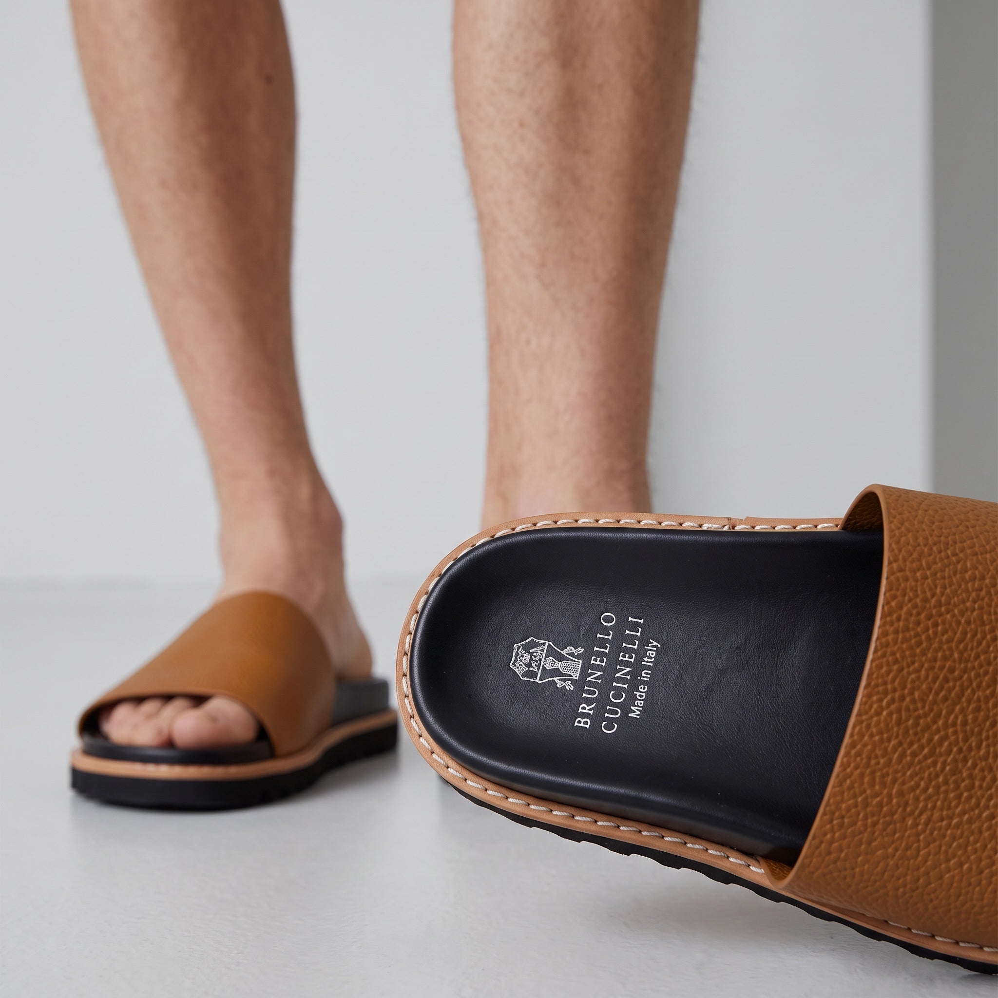 Brunello Cucinelli tan leather men's slide with black cushioned footbed and lug sole