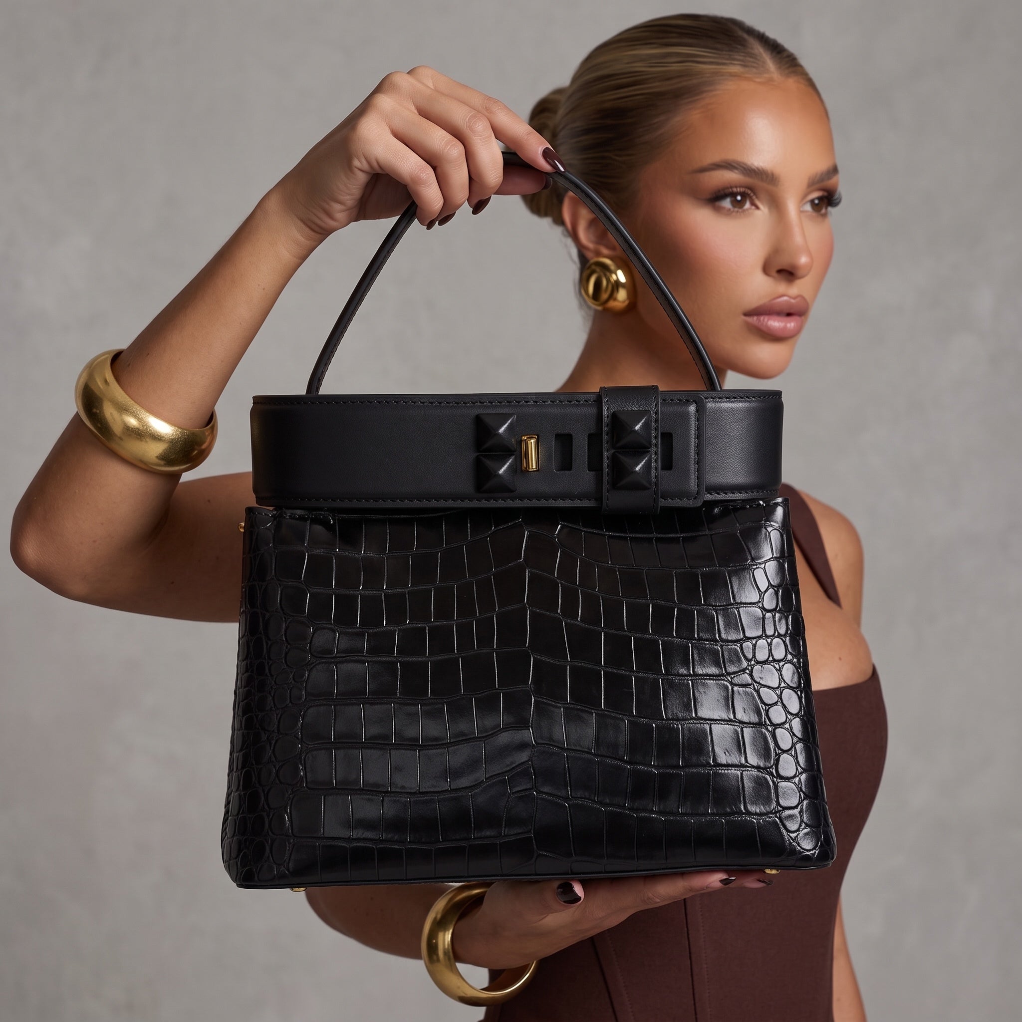 Black croc-effect Valentino tote with pyramid studs and gold clasp, top handle visible