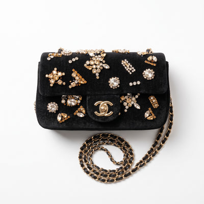 Chanel black velvet flap bag with jeweled embellishments and gold chain strap