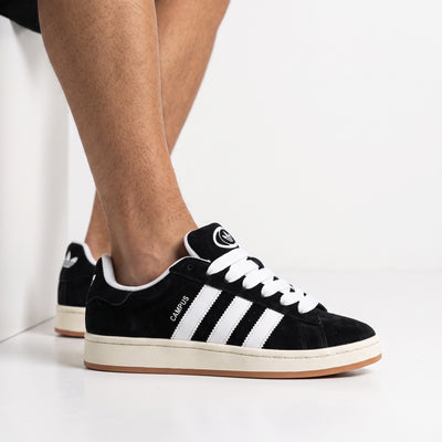 adidas Campus black and white sneakers on foot, side view