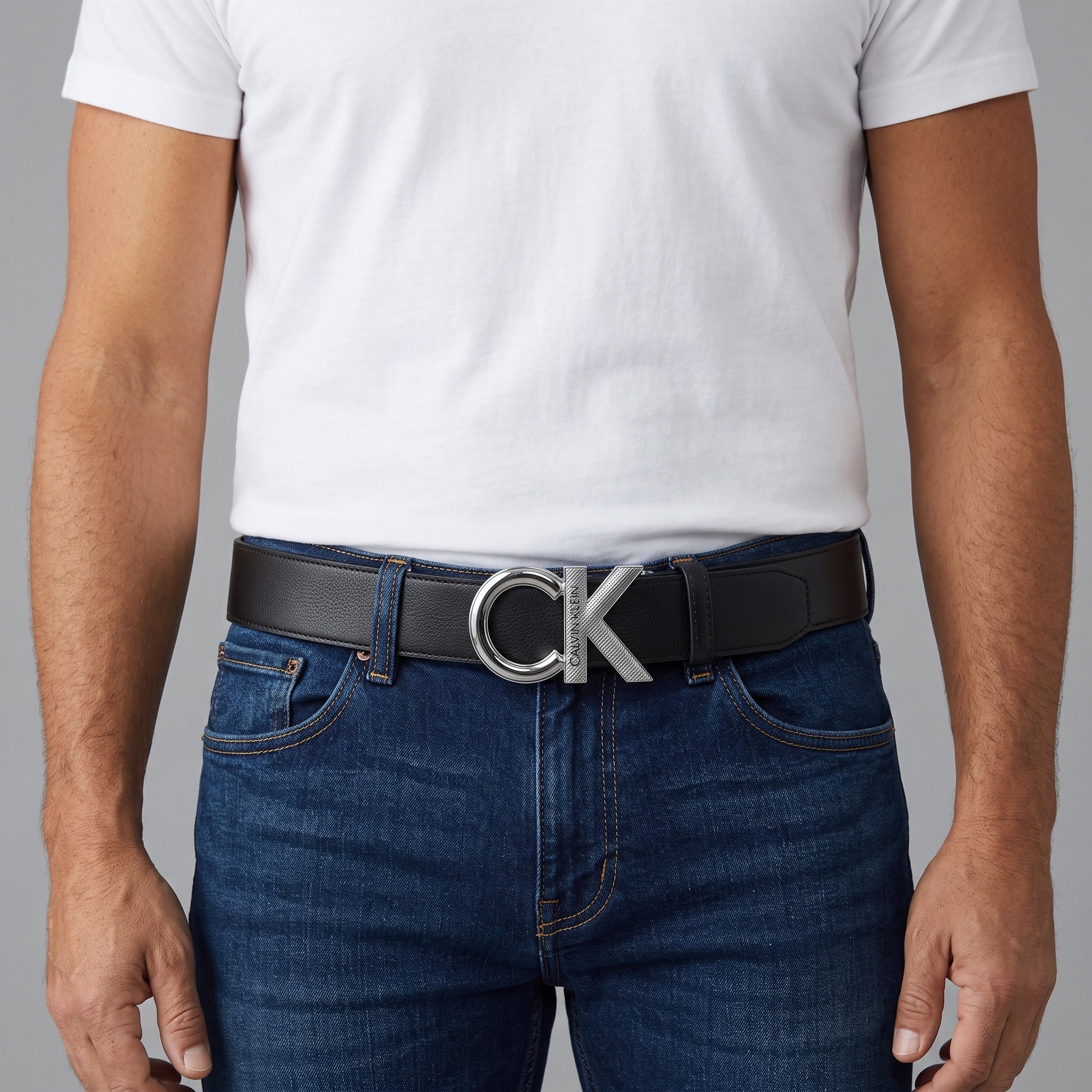 Black Calvin Klein belt with silver CK buckle worn with jeans