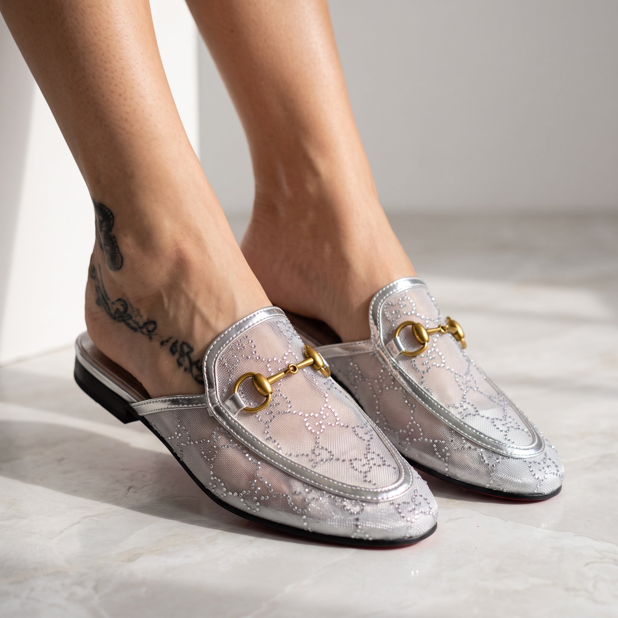 silver Gucci mesh horsebit mule with gold horsebit and red sole