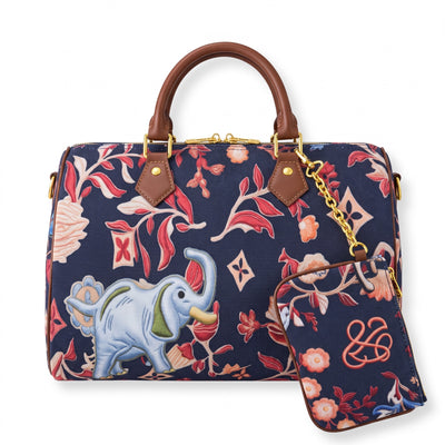 Navy floral top-handle satchel with brown handles, gold chain and elephant motif