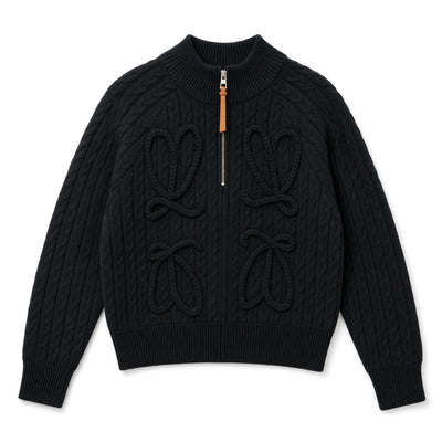 black cable knit zip sweater with tan leather zipper pull and braided loop details